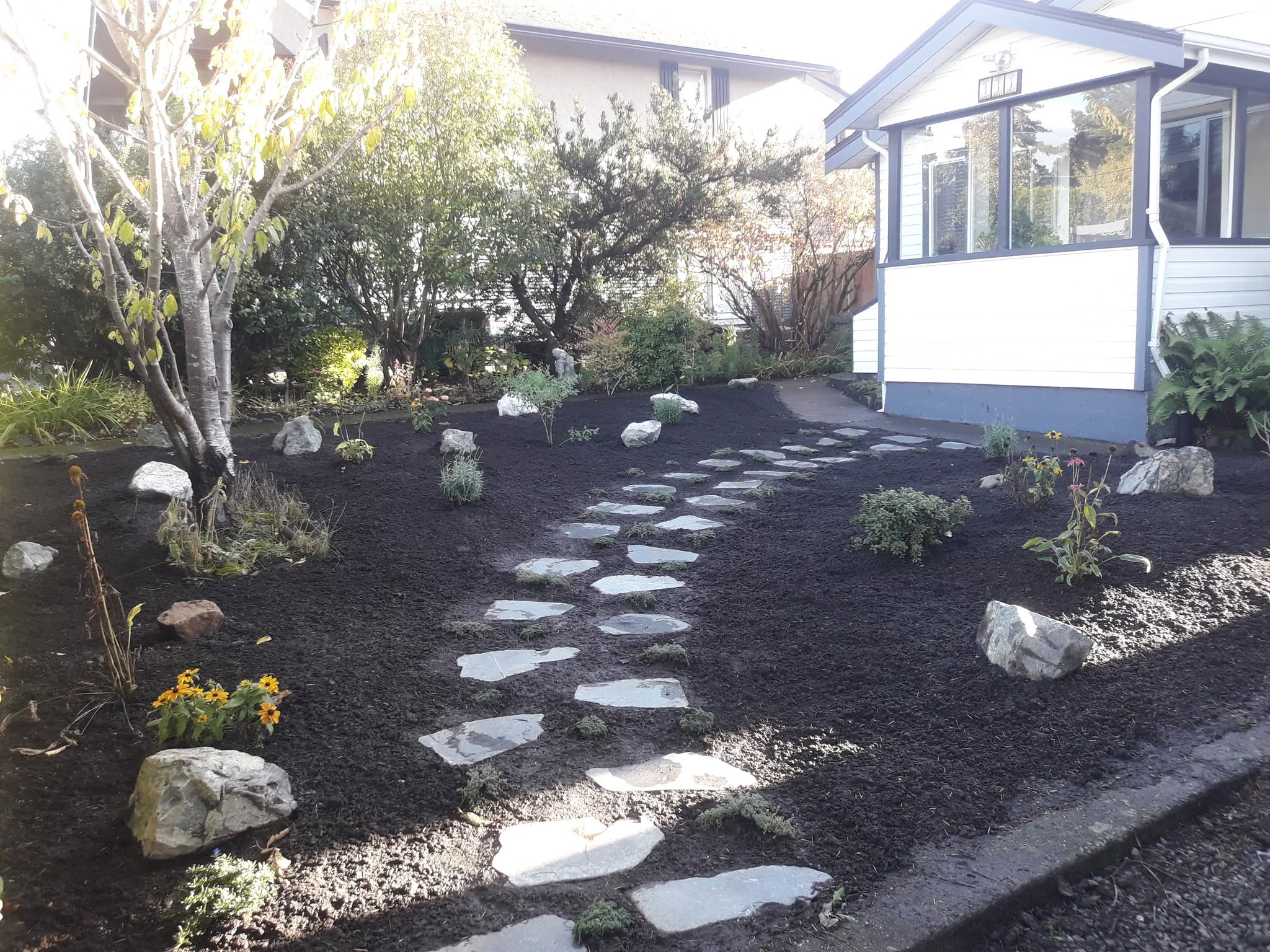 Front yard garden with stepping stone pathway