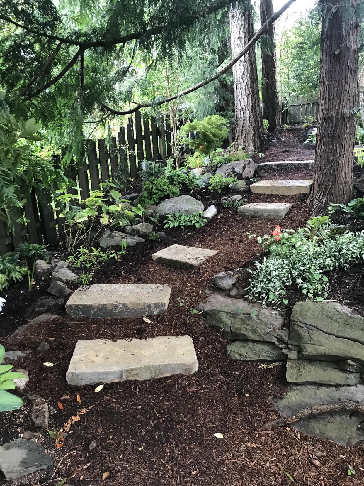 Backyard gravel garden with basalt stone steps
